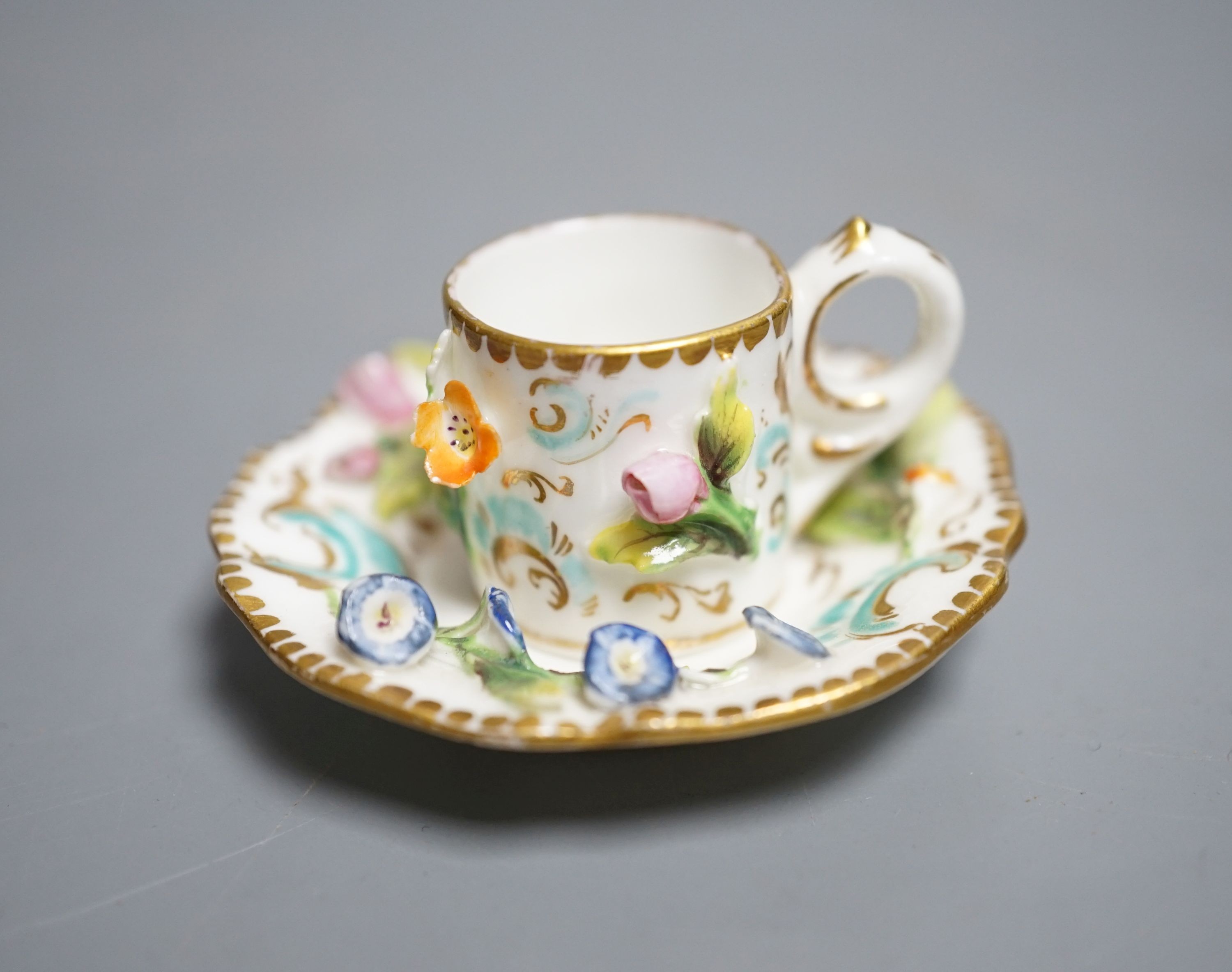 A Coalbrookdale miniature flower encrusted cup and saucer, c.1820. Provenance - Mona Sattin collection of miniature cups and saucers, collection no. 194.